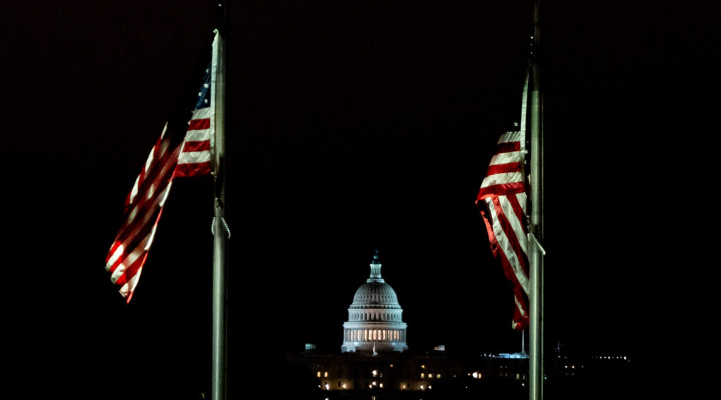 Flags at half-mast in memory of COVID deaths at the Washington Monument with a view of the Capitol on May 24, 2020.