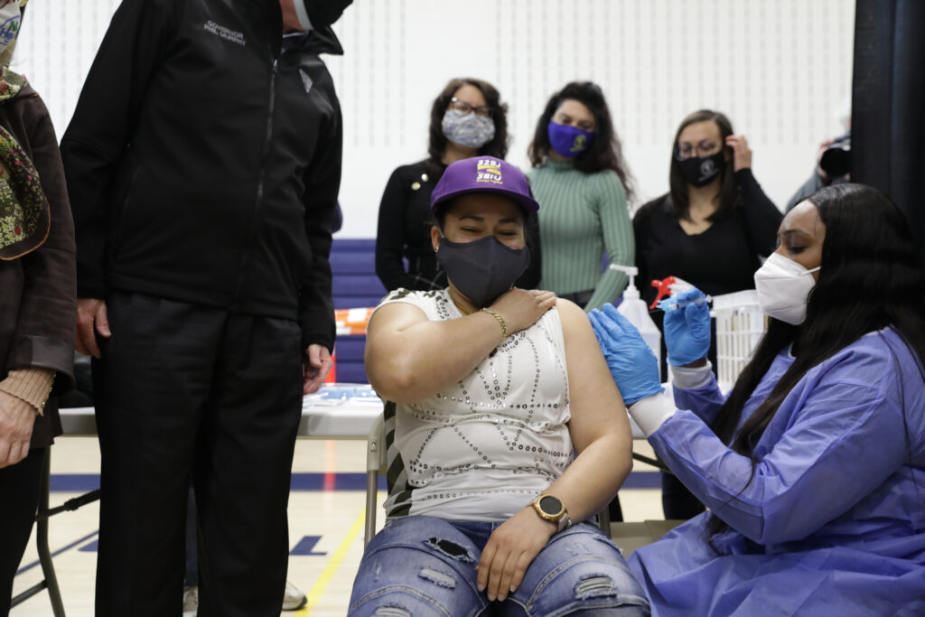 New Jersey Gov. Phil Murphy visits the Donald M. Payne, Sr. School of Technology Community-Based COVID-19 Vaccination Site to observe newly-eligible airport workers from Newark Liberty International Airport get vaccinated on March 16, 2021.