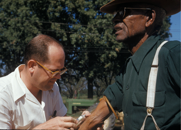 A doctor injects a man with placebo as part of the Tuskegee Syphilis Study.