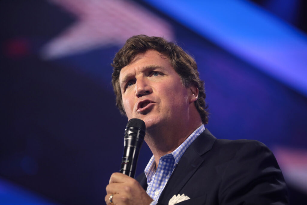 Tucker Carlson speaking with attendees at the 2022 AmericaFest at the Phoenix Convention Center in Phoenix, Arizona.