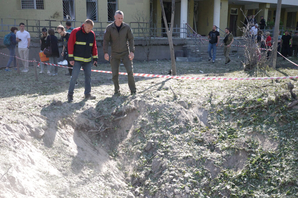 Ukrainians survey the damage from falling missile fragments in a neighborhood in Kyiv after a Russian missile attack on the city this week. Three people died and 10 were injured.