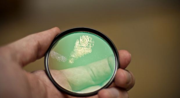 A fingerprint is captured on a camera filter.
