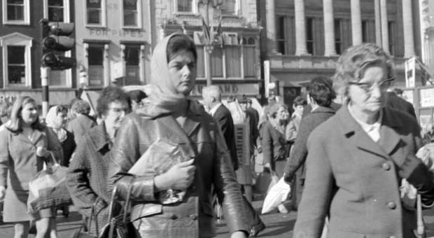Pedestrians crossing from the top of Talbot Street toward Henry Street in Dublin, Ireland, in 1969.
