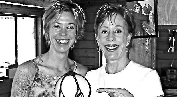 Carol Burnett presenting daughter Carrie with an antique lamp.
