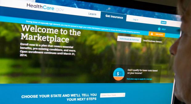 This December 2, 2013 photo shows a woman reading the HealthCare.gov insurance marketplace internet site in Washington, D.C. 