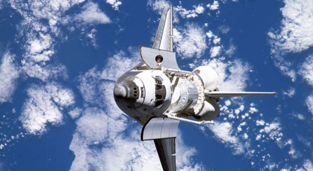 In this handout provided by NASA, backdropped by a blue and white Earth, Space Shuttle Discovery approaches the International Space Station during STS-120 rendezvous and docking operations October 25, 2007. 