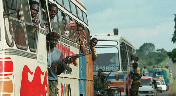 Ugandan soldiers accompany a convey of buses and private cars into the northern Ugandan town of Gulu on March 21, 1996, after Ugandan Lord's Resistance Army (LRA) rebels attacked three villages in the northern part of the country March 18 and 19, killing 34 people. 