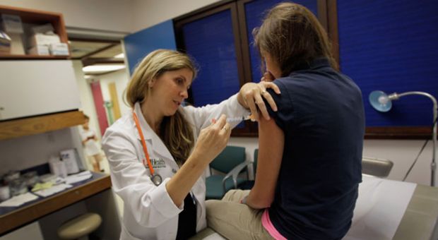 University of Miami pediatrician Judith L. Schaechter, M.D. gives an HPV vaccination to a 13-year-old girl in her office at the Miller School of Medicine on September 21, 2011 in Miami, Fla. 