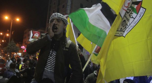 Palestinian supporters of the Fatah movement demonstrate in support of the Palestinian president Mahmud Abbas in the West Bank town of Hebron on April 1, 2014 following his speech after signing a demand to join several United Nations agencies. 'The Palestinian leadership has unanimously approved a decision to seek membership of 15 UN agencies and international treaties, beginning with the Fourth Geneva Convention,' Abbas said on television after signing the demand during a meeting at his Ramallah headquarters.