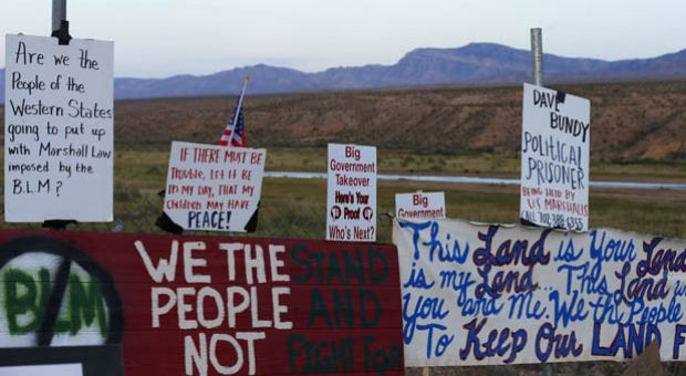 Protesters hang signs on a fence along US. highway 170 protesting the closure of thousands of acres of Bureau of Land Management land that has been temporarily closed to round-up illegal cattle that are grazing south of Mesquite Nevada on April 10, 2014 in Mesquite, Nevada. BLM officials are rounding up ranchers Cliven Bundy's cattle, who has been locked in a dispute with the BLM for a couple of decades over grazing rights.  