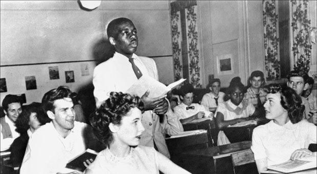 A black student, Nathaniel Steward, 17, recites his lesson surrounded by white fellows and others black students on May 21, 1954 at the Saint-Dominique school in Washington, where for the first time the Brown v Board of Education decision was applied.