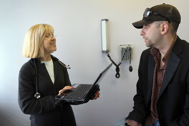 Dr. Klara Gershman uses a laptop computer to enter information about her patient in Miami Beach, Florida.