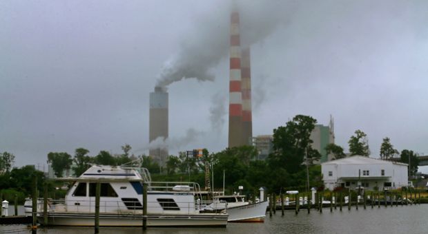 A boat stands in the shadow of the coal-fired Morgantown Generating Station, on May 29, 2014 in Newburg, Maryland. 