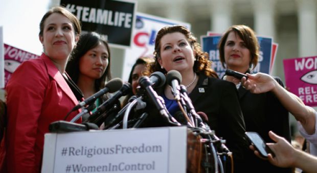 Lori Windham (C), senior counsel for The Becket Fund for Religious Liberty,addresses the news media in front of the Supreme Court after the decision in Burwell v. Hobby Lobby Stores June 30, 2014 in Washington, DC. The high court ruled 5-4 that requiring family-owned corporations to pay for insurance coverage for contraception under the Affordable Care Act violated a federal law protecting religious freedom.