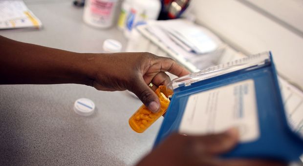 A pharmacy technician counts out a prescription of antibiotic pills August 7, 2007 in Miami, Florida. 