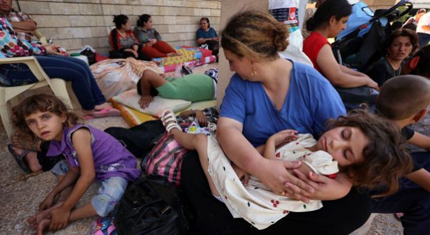 Iraqi Christians who fled the violence in the village of Qaraqush, about 30 kilometers east of the northern province of Nineveh, rest upon their arrival at the Saint-Joseph church in the Kurdish city of Arbil, in Iraq's autonomous Kurdistan region, on August 7, 2014. Gunmen from the Sunni Muslim Islamic State (IS) seized Qaraqush, Iraq's largest Christian town, and several others near Mosul following the withdrawal of Kurdish peshmerga fighters, inhabitants said.  