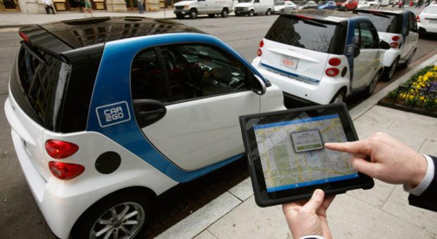A car2go employee shows how members can use a smartphone or iPad app to locate and reserve car2go vehicles in Washington, DC. In 2012, car2go offered the first free-floating car-sharing service in Washington and Portland, Oregon.
