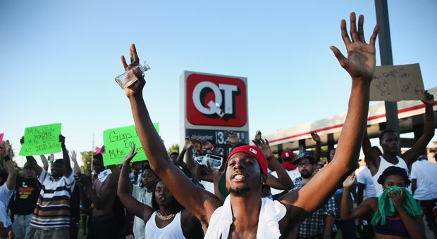 Demonstrators protest the killing of teenager Michael Brown on August 12, 2014 in Ferguson, Missouri. 