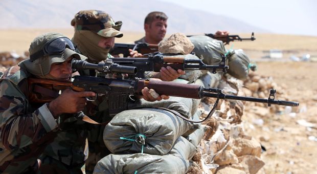 Iraqi Kurdish Peshmerga fighters monitor the area from their front line position in Bashiqa, a town 13 kilometres north-east of Mosul on August 16, 2014. Kurdish troops backed by US warplanes launched a bid to recapture Mosul dam, Iraq's largest, from Islamic State jihadists, a senior Kurdish military official said.  