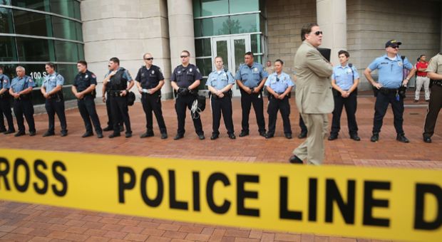 Police guard the front of the Buzz Westfall Justice Center where a grand jury will begin looking at the circumstances surrounding the fatal police shooting of an unarmed teenager Michael Brown on August 20, 2014 in Clayton, Missouri.  