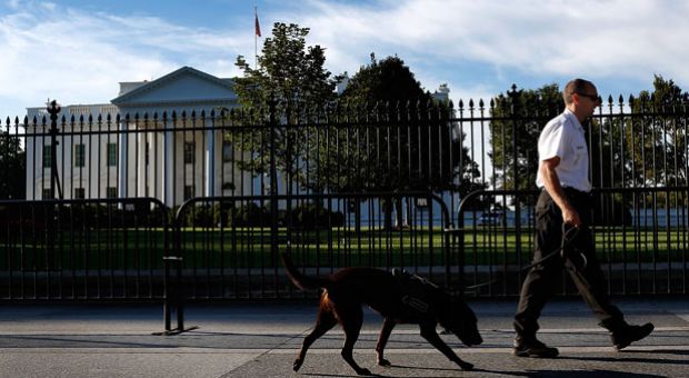 A uniformed Secret Service officer patrols outside the White House on Pennsylvania Avenue with a member of the canine team on Sept. 23, 2014 in Washington, D.C. An additional small fence has been added to the perimeter of the White House following an incident last week where a man jumped the fence and gained access to the interior of the building. 