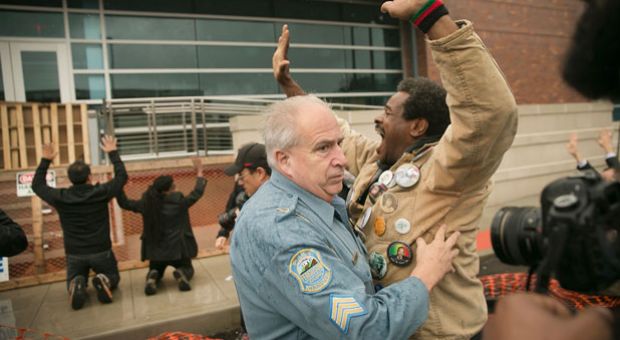 Demonstrators confront police outside the Ferguson police station on October 13, 2014 in Ferguson, Missouri. Ferguson has been struggling to heal since riots erupted following the August 9, killing of 18-year-old Michael Brown by a police officer in suburban Ferguson. Another teenager, Vonderrit Myers Jr., was killed by a St. Louis police officer on October 8. Several demonstrators and members of the clergy were arrested at the protest after a show of civil disobedience. 