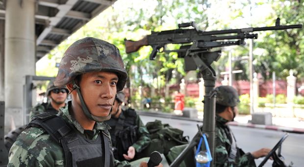 Thai army soldiers stand guard on a city street after martial law was declared on May 20, 2014 in Bangkok, Thailand. The army imposed martial law across Thailand amid a deepening political crisis that has seen six months of protests and claimed at least 28 lives. 