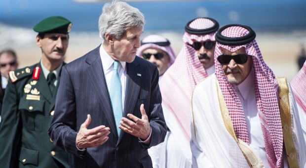 US Secretary of State John Kerry (L) and Saudi Foreign Minister Prince Saud al-Faisal (R) walk together upon Kerry's arrival on June 27, 2014 at King Abdulaziz International Airport in the Saudi city of Jeddah. Kerry arrived in Saudi Arabia to meet the Syrian opposition, a day after hosting urgent talks on Syria and Iraq in Paris, as Washington unveiled plans to provide some $500 million in arms and training to the Syrian rebels.