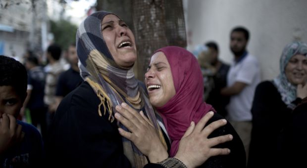 Palestinian women grieve over the death of relatives outside the morgue of the Kamal Adwan hospital in Beit Lahiya, on July 24, 2014, after a UN school in the northern Beit Hanun district of the Gaza Strip was hit by an Israeli shell. 