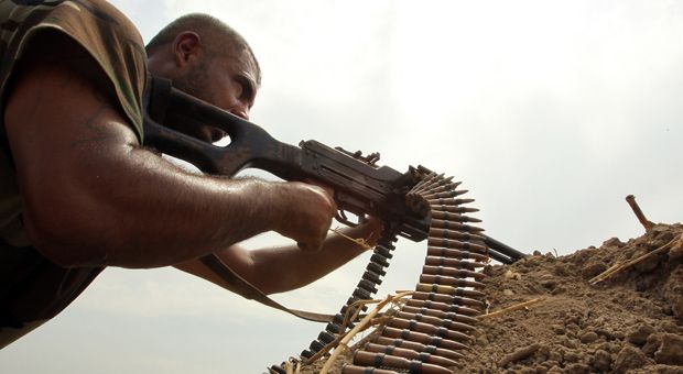 A Shiite fighter loyal to Iraqi Shiite cleric Moqtada al-Sadr holds a position as they back the Iraqi army in the fight against Islamic State (IS) militants after re-taking control of an area in the Jurf al-Sakher district about 65 kilometres south of Baghdad. Since last week, the United States has conducted strikes on IS positions.  
