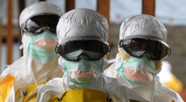 Health care workers, wearing protective suits, leave a high-risk area at the French NGO Medecins Sans Frontieres (Doctors without borders) Elwa hospital on August 30, 2014 in Monrovia.  