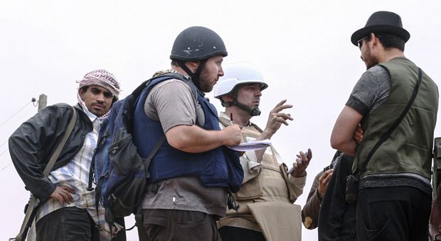 In this handout image made available by the photographer American journalist Steven Sotloff (Center with black helmet) talks to Libyan rebels on the Al Dafniya front line, 25 km west of Misrata on June 02, 2011 in Misrata, Libya. Sotloff was kidnapped in August 2013 near Aleppo, Syria. A video released Tuesday by ISIS claims to show Sotloff's execution.