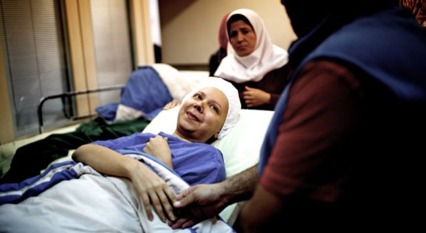 Iranian breast cancer patient Farvah shares a moment with her fiance Saleh on her way to the operation room.