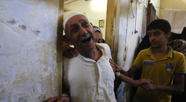 Relatives and friends of al-Hajj family mourn as they gather in a mosque to pray over the bodies of the eight family members during their funeral in Khan Yunis, in the southern Gaza Strip, on July 10, 2014. 