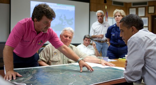 Grand Isle (Louisiana) Mayor David Camardelle points out areas on a map relating to the BP oil spill during a briefing with President Barack Obama at the U.S. Coast Guard Station in Grand Isle, La., May 28, 2010. 