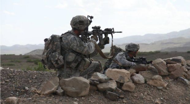 U.S. Army Sgt. Maj. Mark Bartosch and Staff Sgt. Bradley Watts pull security on the outskirts of the village of Margah, during a presence patrol. Sgt. Maj. Bartosch is the Operations Sgt. Maj. for the 187th Infantry and Staff Sgt. Watts is a member of 4th Platoon, ABU Company, 1-187th Infantry (Air Assault), Combat Outpost Margah, Paktika Province, Afghanistan, 6 May 2010.