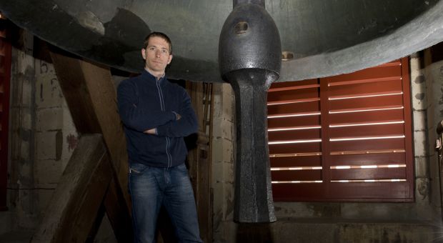 Author Richard Harvell next to a bell in the Church of St. Gall, Switzerland