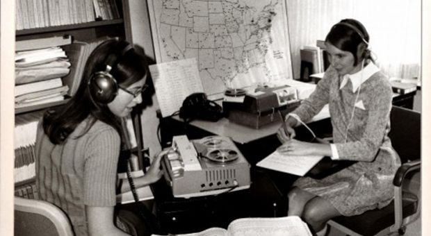 Beth Witherell and Jennifer Ellsworth, graduate students who worked on DARE, listen to one of the more than 1,800 audio recordings made in the field. Their job was to transcribe pronunciations in phonetics and select parts of conversations for examples of words to include in DARE. 