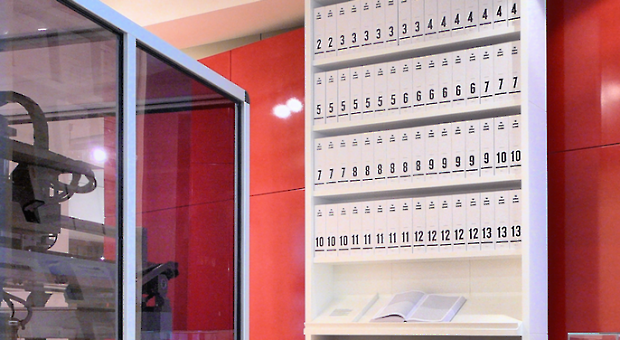 The first printout of the human genome to be presented as a series of books, displayed in the "Medicine Now" room at the Wellcome Collection, London. The 3.4 billion units of DNA code are transcribed into more than a hundred volumes, each 1,000 pages long, in type so small as to be barely legible.