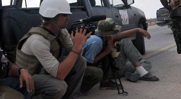 A photo taken on September 29, 2011 shows US freelance reporter James Foley (L) on the highway between the airport and the West Gate of Sirte, Libya. A video released this week shows an ISIS militant beheading Foley in what is believed to be retaliation for U.S. airstrikes in Iraq