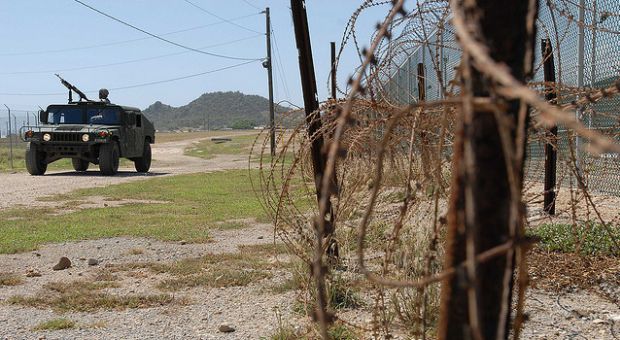 A Humvee from the Puerto Rico Army National Guard's, 480th Military Police Company, patrols the perimeter of the detention facility at Guantanamo Bay Naval Base, Cuba, Oct. 7, 2009