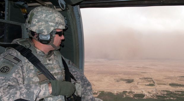 Col. Mark R. Stammer, commander of 1st Brigade, 82nd Airborne Division (Advise and Assist Brigade), watches a dust storm blow toward the Euphrates River and his UH-60 Black Hawk helicopter May 10, 2010
