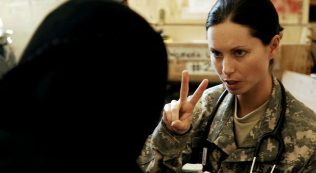 U.S. Army Capt. Jody Brown, a physician from Charlie Company, 225th Brigade Support Battalion, 2nd Stryker Combat Brigade Team, 25th Infantry Division, prescribes medication to a patient during a combined medical outreach program in Bata, Iraq, March 17, 2008