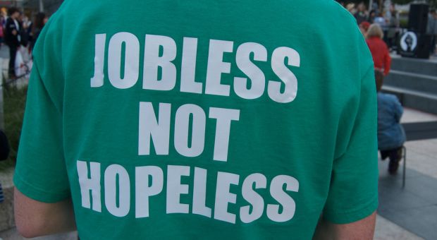 Job seeker Chris Stewart, in San Francisco last year, wears a shirt that includes his contact information on the front and reads "Jobless Not Hopeless: Ask For My Resume" on the back. 