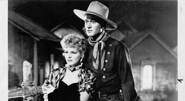 John Wayne is pictured here in a still from "Stagecoach" with Claire Trevor. 