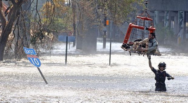 A man is rescued by a military helicopter, near the I-10 Freeway, a week after hurricane Katrina, in New Orleans, Louisiana, on September 7, 2005