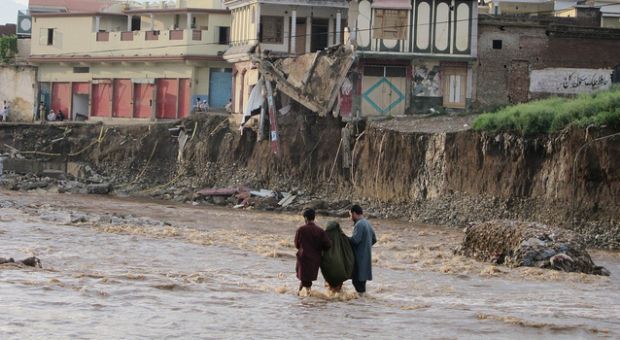 Many roads in Swat are now completely damaged which makes it hard for people to travel and for aid workers to deliver much needed supplies. In this picture two young men are helping an old woman to walk through a path, which was completely submerged.