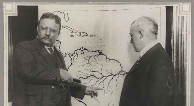 President Roosevelt points at a map of South America to highlight the area explored during the Roosevelt-Rondon Scientific Expedition in Brazil.

	