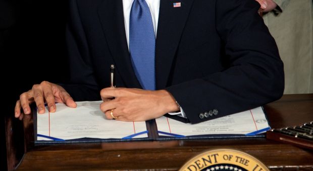 President Barack Obama signs the health insurance reform bill in the East Room of the White House, March 23, 2010.