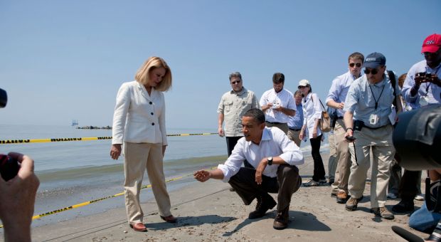 President Barack Obama and Lafourche Parish President Charlotte Randolf, left, inspect a tar ball as they look at the effect the BP oil spill is having on Fourchon Beach in Port Fourchon, La., May 28, 2010